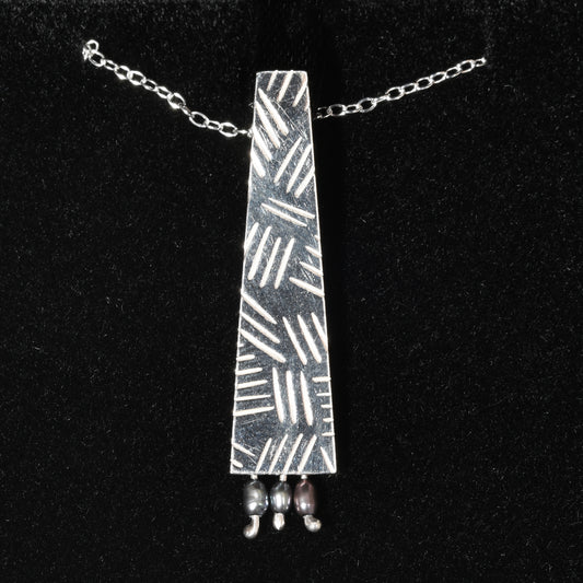 Silver cross hatch necklace with blue pearls