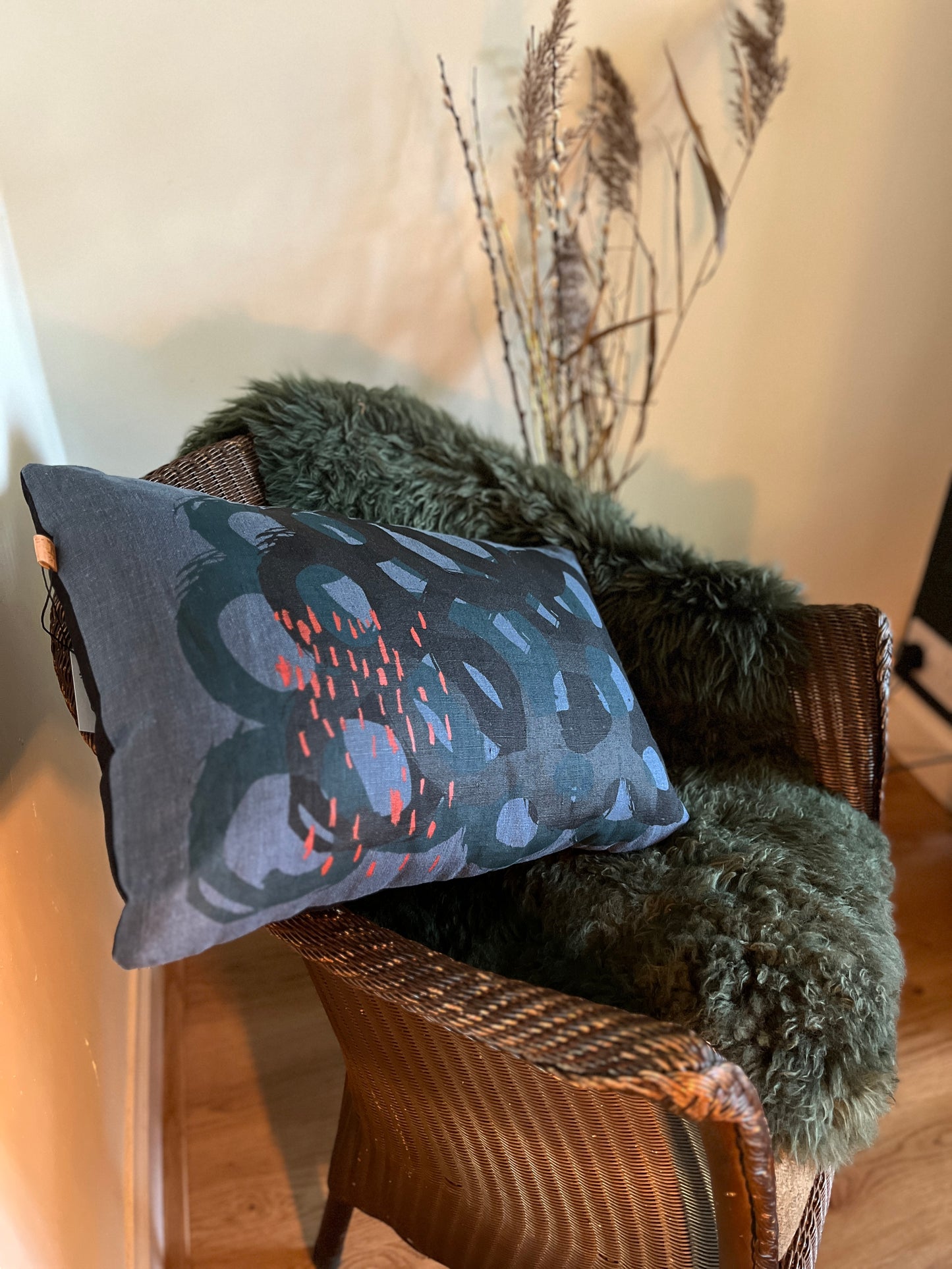 Rings cushion- A stunning cushion in a graphic, modern design in a beautiful palette of Storm Blue, Black, Teal and a touch of Brick Red.  50 x 34 cms.  Comes with an ethically sourced feather cushion pad and an invisible zip opening.  Gentle hand wash.  100% Linen.