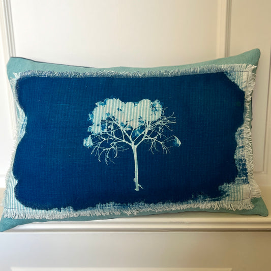 A unique handmade cushion featuring original cyanotype print on a striped linen panel. Each cyanotype piece is made individually by me so every one is an original.The cushion has fringe edge detail and is in aqua linen for the front and indigo blue canvas for the back.